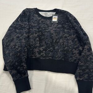 Women’s Camo Under Armour sweater. New with tags. Size Small.